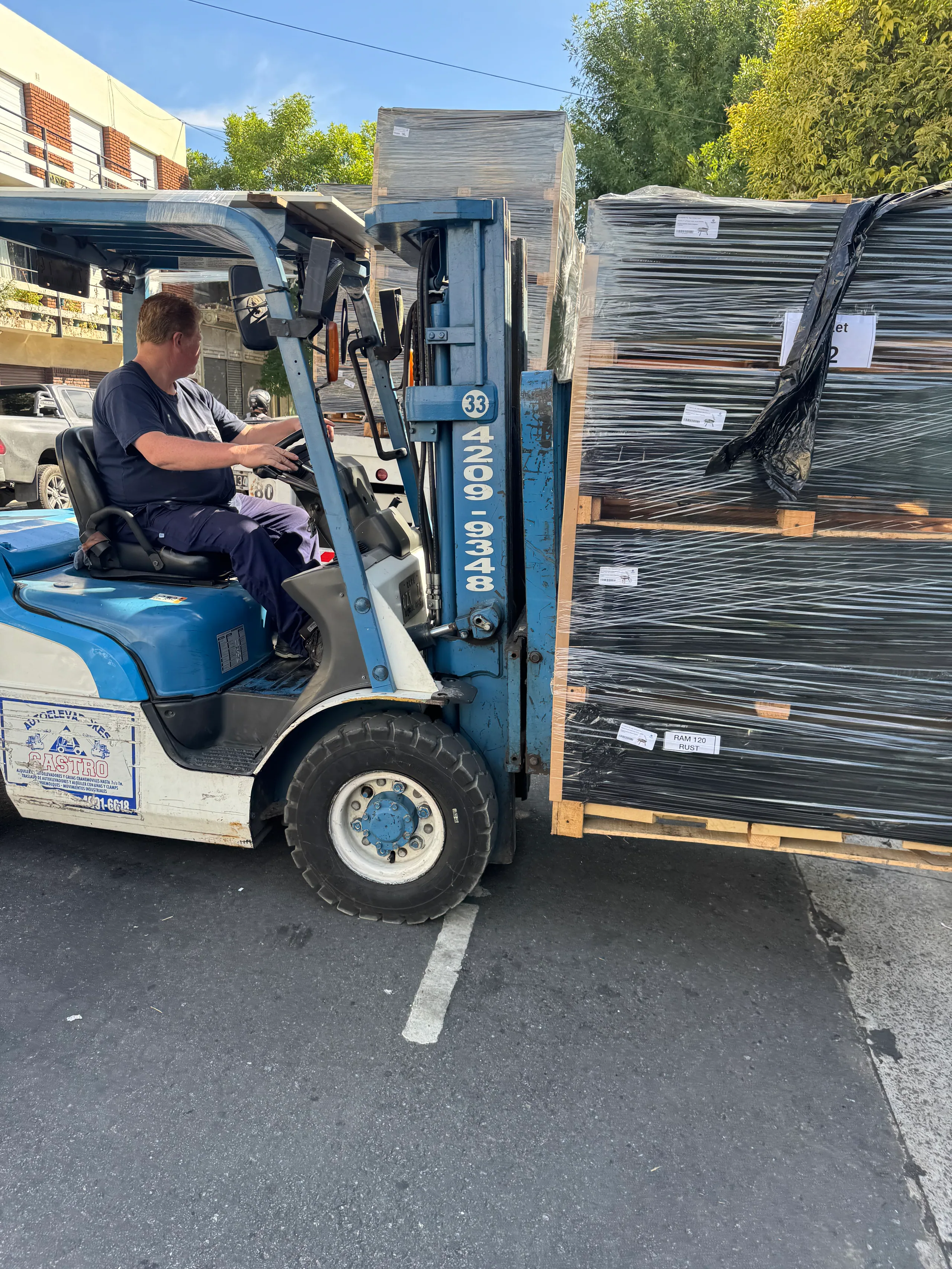 A forklift loading pallets of grills for export