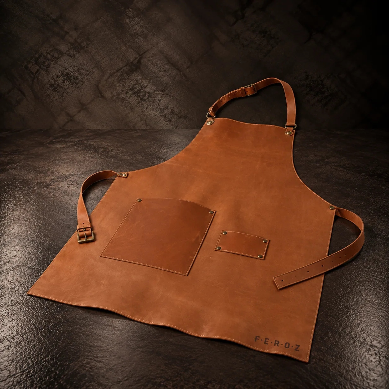 The 100% leather apron, on dark stone