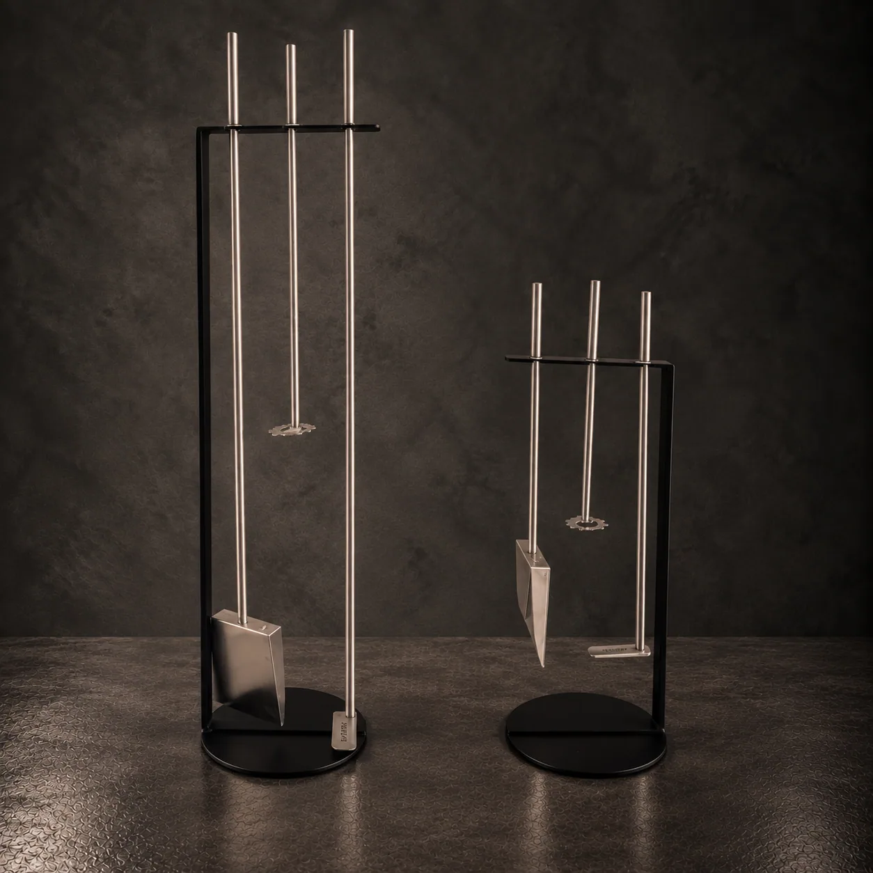 The Ángaro poker and shovel standing on their bases, on dark stone