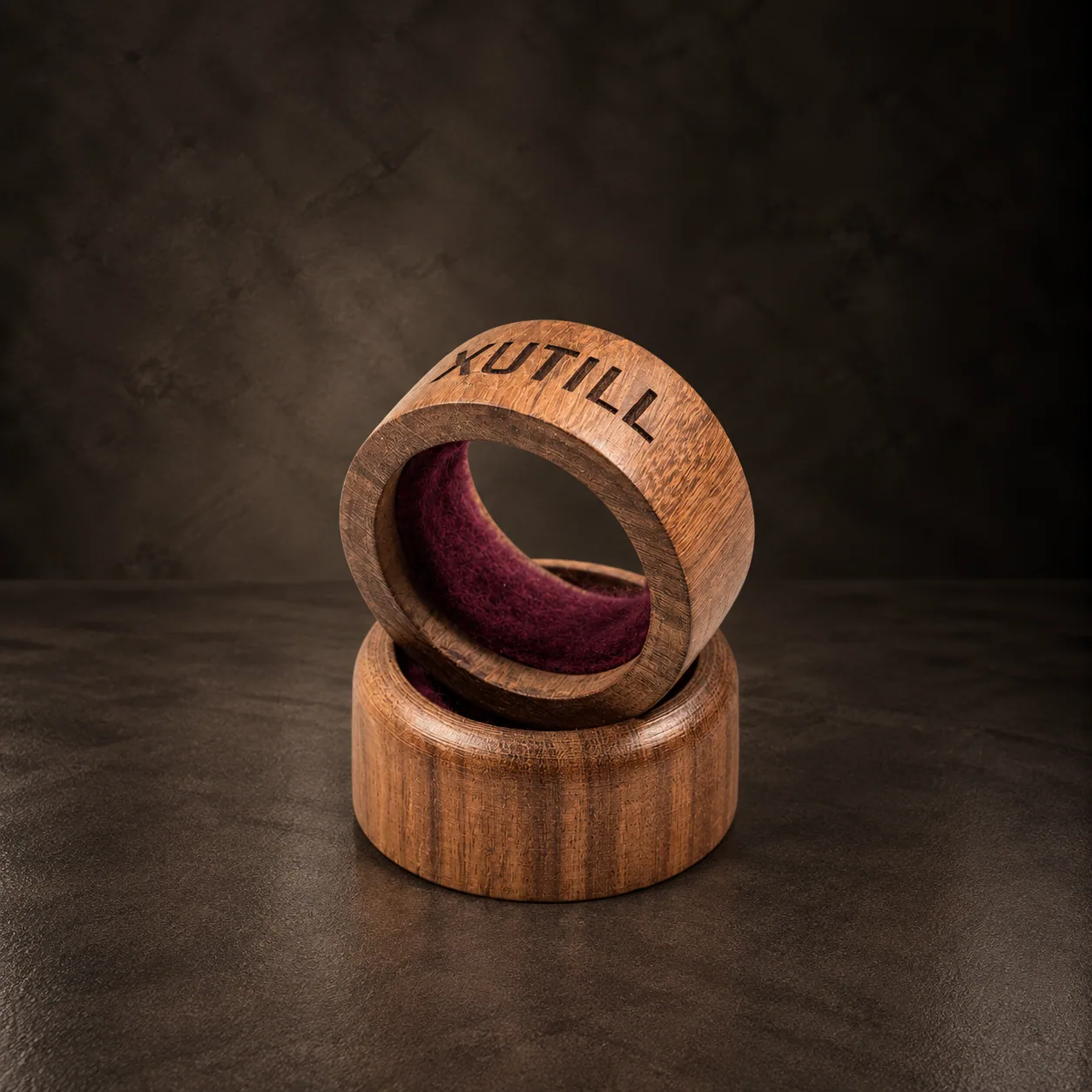 The two felt-lined wooden drip rings, on dark stone