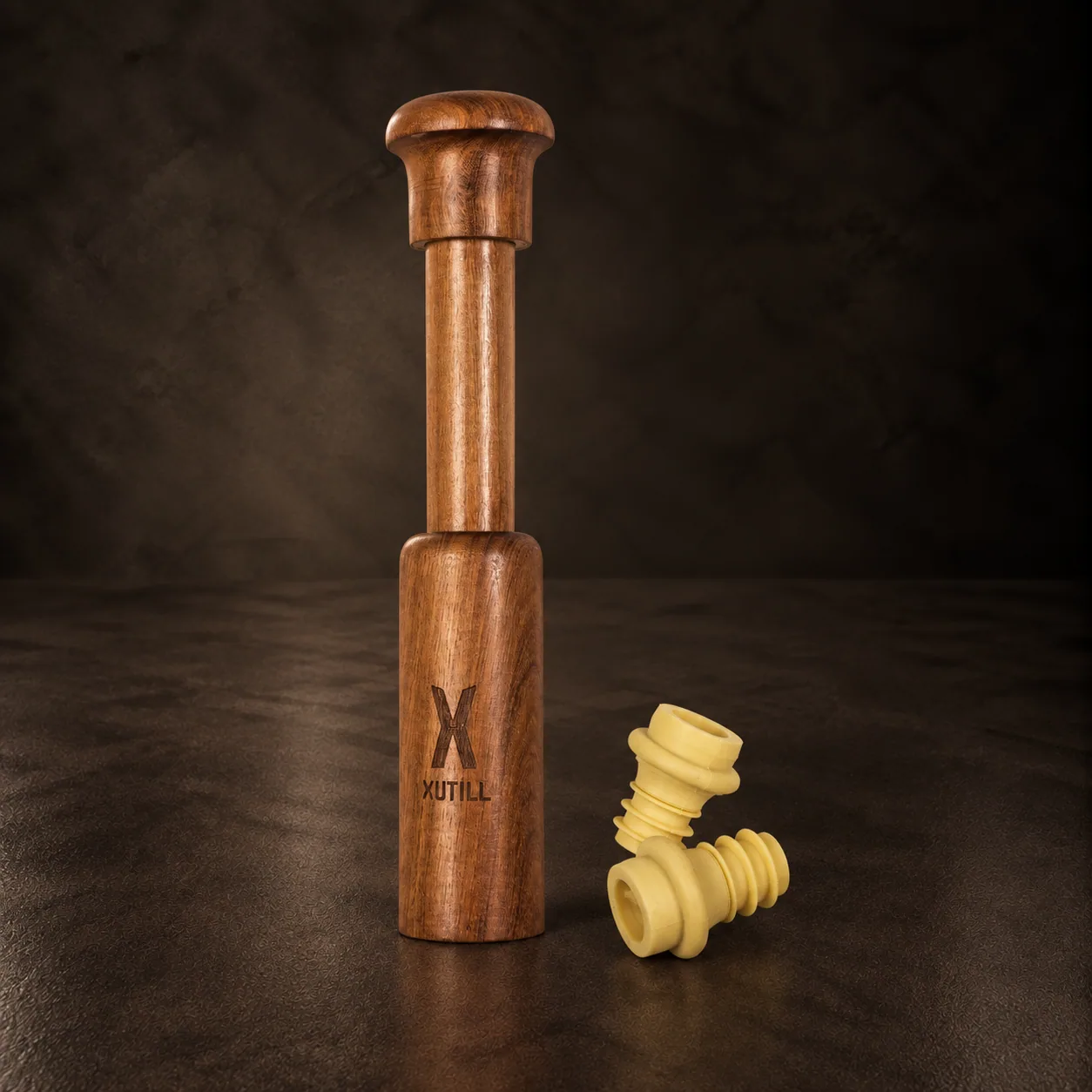 The wooden vacuum wine saver pump with its stoppers, on dark stone